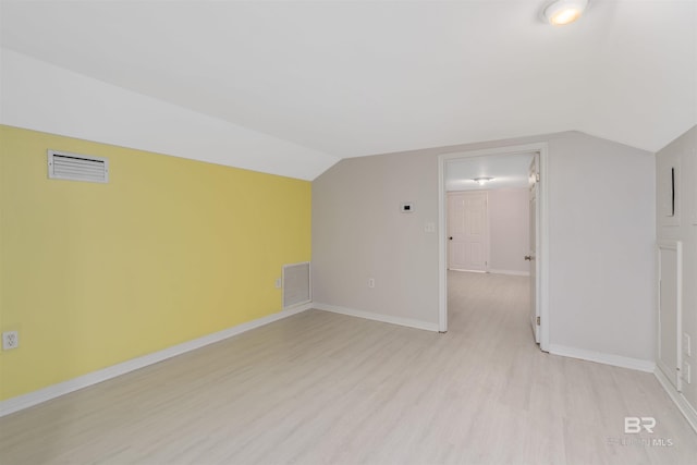 additional living space with lofted ceiling and light hardwood / wood-style flooring