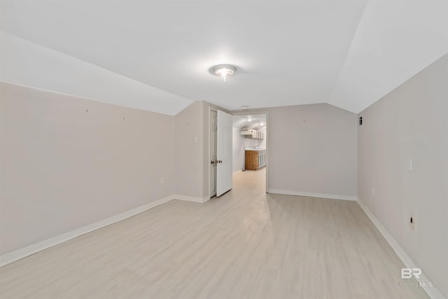 bonus room featuring light hardwood / wood-style flooring and lofted ceiling