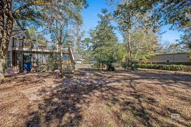 view of yard featuring a wooden deck