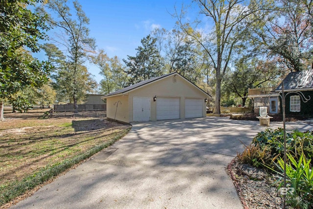 view of side of home featuring an outbuilding and a garage