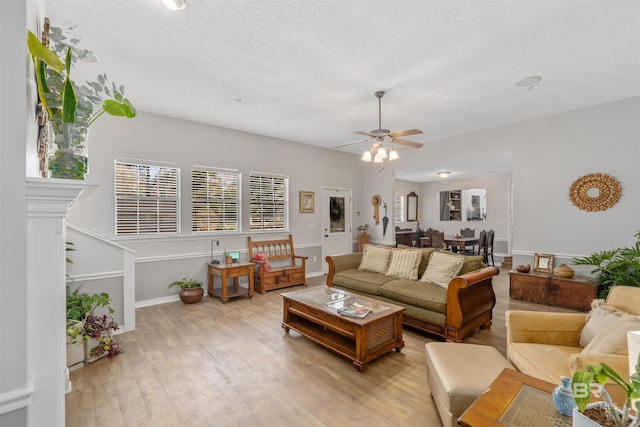 living room with ceiling fan and light hardwood / wood-style floors