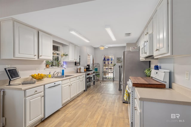 kitchen featuring white cabinetry, sink, white appliances, and ceiling fan