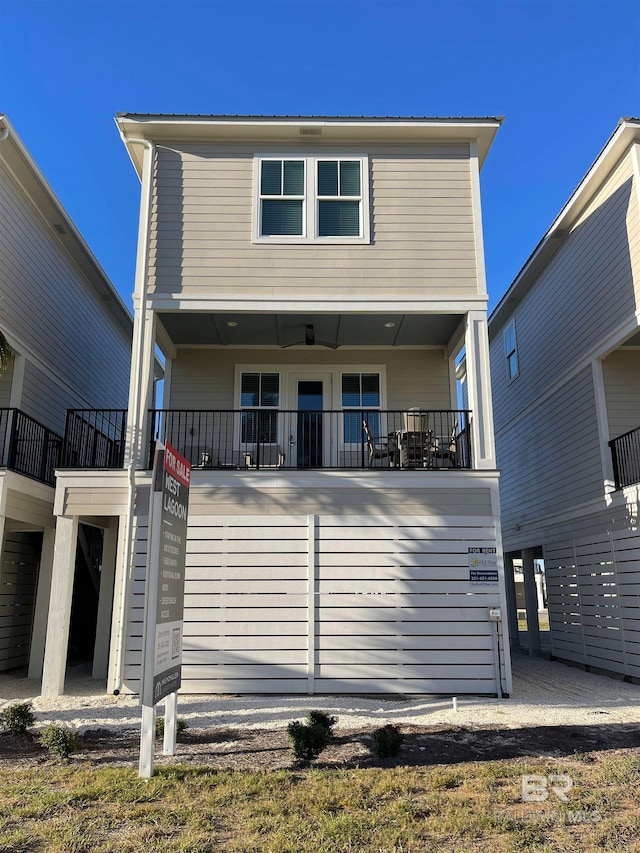 back of property with a balcony