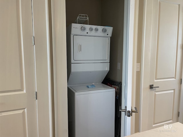 laundry room with stacked washer and clothes dryer and laundry area