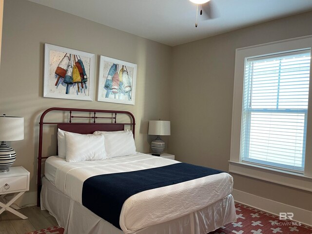 bedroom with wood-type flooring and ceiling fan