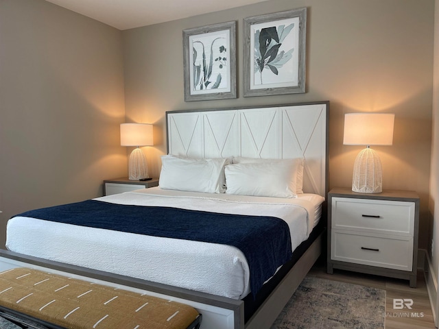 bedroom with dark wood-type flooring