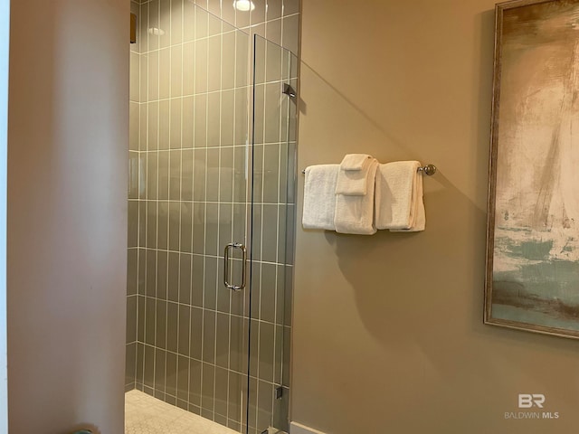 bathroom featuring a shower with shower door