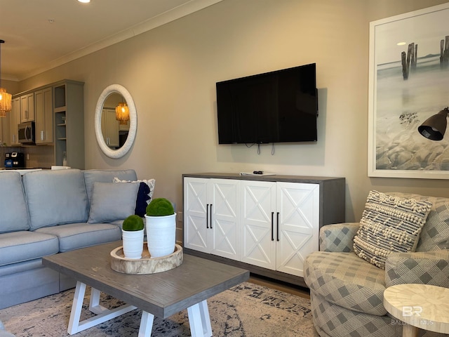 living room with crown molding and a notable chandelier