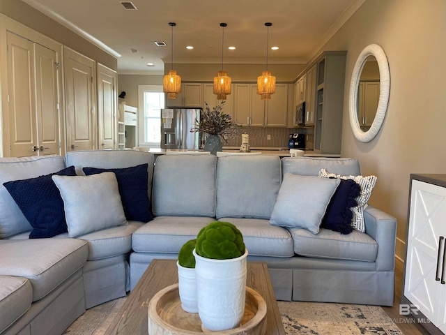 living room featuring ornamental molding and light wood-type flooring