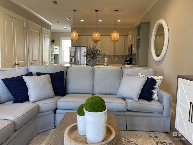 living room with recessed lighting and crown molding