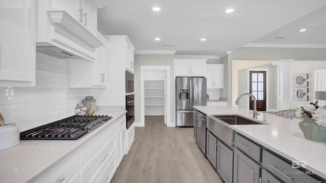 kitchen with sink, gray cabinets, white cabinetry, stainless steel appliances, and custom exhaust hood