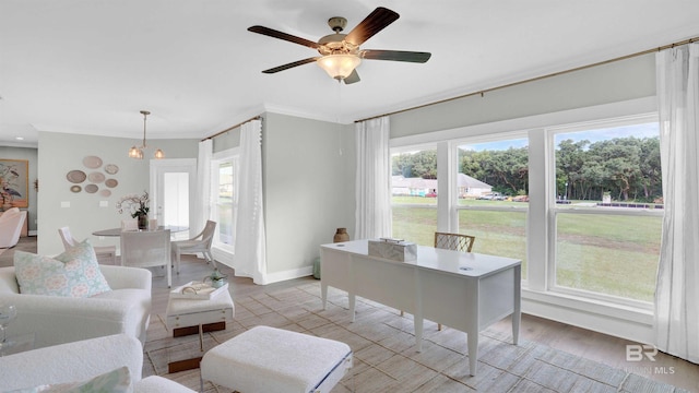 living room featuring ceiling fan with notable chandelier, ornamental molding, and light wood-type flooring