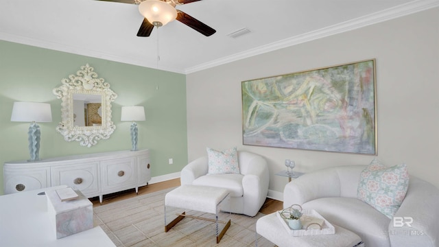 sitting room with ornamental molding, ceiling fan, and light hardwood / wood-style flooring