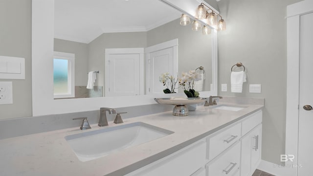 bathroom with ornamental molding and vanity