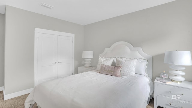 bedroom featuring light carpet and a closet