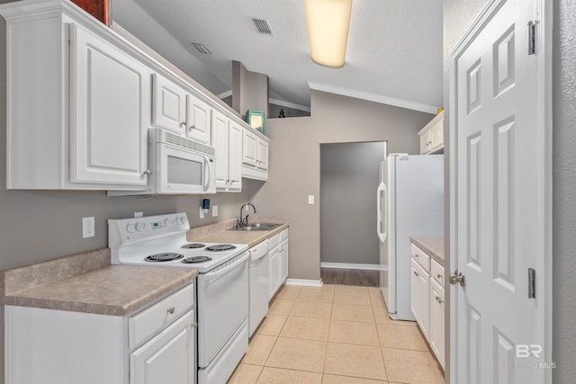 11097 Pontchartrain Loop, Daphne, AL 36526 - kitchen featuring white appliances, ornamental molding, white cabinetry, light tile patterned flooring, and vaulted ceiling