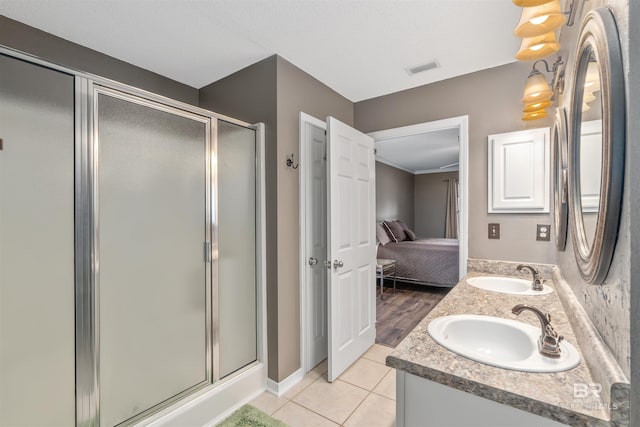 11097 Pontchartrain Loop, Daphne, AL 36526 - ensuite bathroom with a shower stall, double vanity, and tile patterned flooring