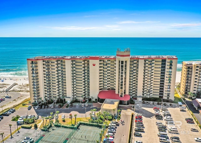 birds eye view of property featuring a water view and a beach view