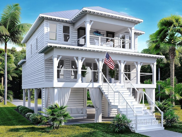 coastal home with a porch, metal roof, stairway, and a balcony