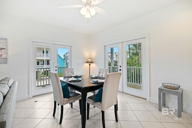 tiled dining area with ceiling fan and french doors