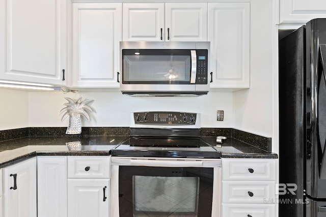 kitchen with white cabinetry, dark stone counters, and stainless steel appliances