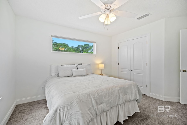 bedroom with a closet, ceiling fan, and carpet floors