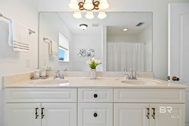 bathroom with walk in shower and vanity