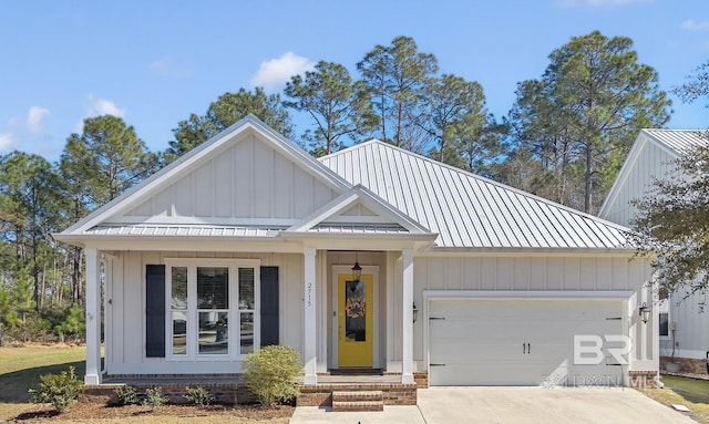 modern inspired farmhouse featuring a garage, driveway, metal roof, and board and batten siding