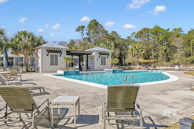 pool with fence, an outbuilding, and a patio