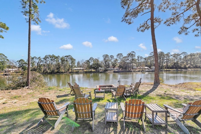 view of yard with a water view and a fire pit