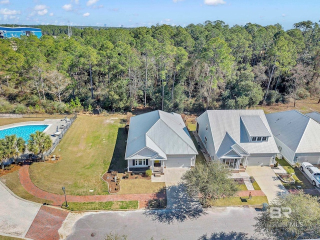 drone / aerial view featuring a wooded view