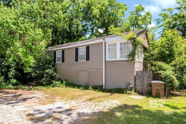 view of property exterior featuring fence