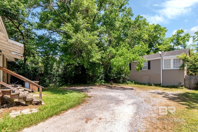 view of street with driveway and stairway