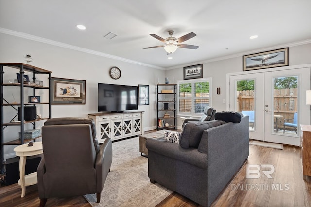 living area featuring ornamental molding, wood finished floors, recessed lighting, a ceiling fan, and french doors