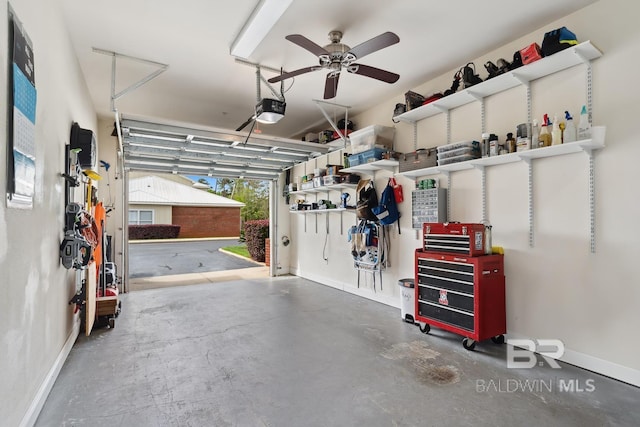 garage with baseboards, a garage door opener, and a ceiling fan