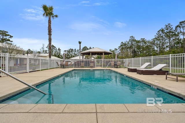 pool with a gazebo, fence, and a patio area
