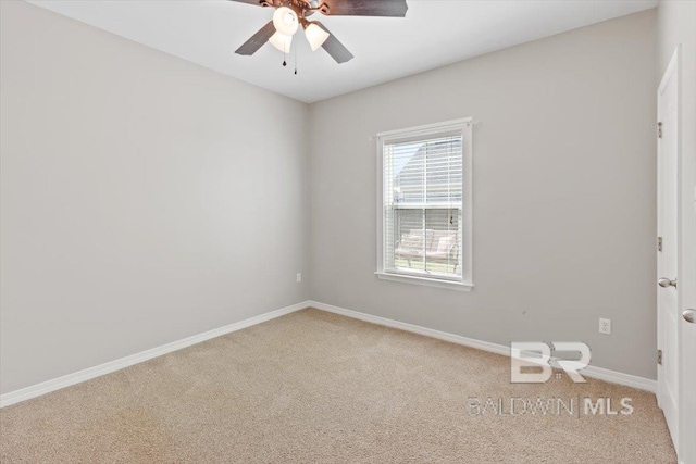 carpeted empty room with baseboards and a ceiling fan