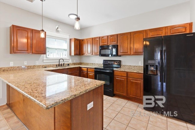 kitchen featuring a peninsula, a sink, hanging light fixtures, black appliances, and brown cabinetry