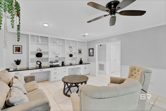 living room with light tile patterned floors, crown molding, visible vents, and built in desk