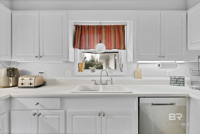 kitchen featuring a sink, white cabinets, stainless steel dishwasher, and light countertops