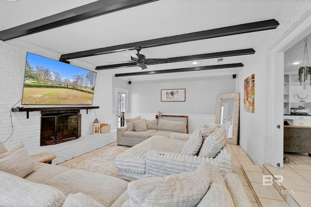 tiled living area with brick wall, beamed ceiling, a brick fireplace, and a ceiling fan