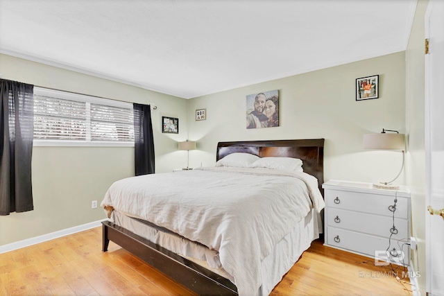 bedroom with light wood-style flooring and baseboards