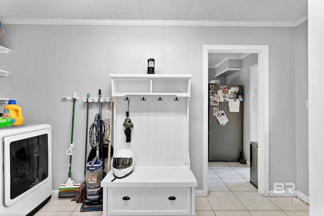 mudroom featuring washer / clothes dryer, crown molding, and light tile patterned flooring