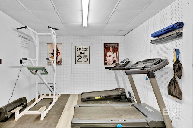 exercise area with a paneled ceiling