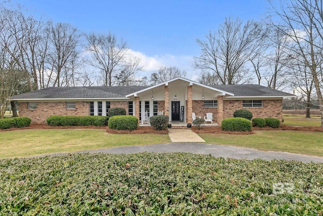 view of front of house with a front yard and brick siding