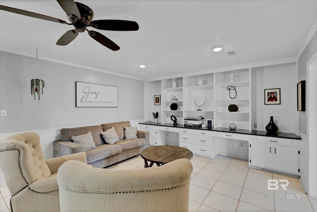 living area with crown molding, light tile patterned floors, visible vents, a ceiling fan, and built in study area