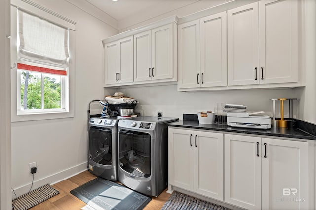 452 Colony Dr, Fairhope, AL 36532 - laundry area with cabinet space, baseboards, separate washer and dryer, and light wood-style floors