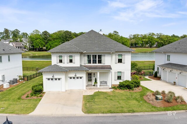 452 Colony Dr, Fairhope, AL 36532 - traditional home featuring driveway, a shingled roof, a water view, and fence