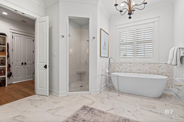452 Colony Dr, Fairhope, AL 36532 - bathroom with a soaking tub, a chandelier, a shower stall, wainscoting, and marble finish floor