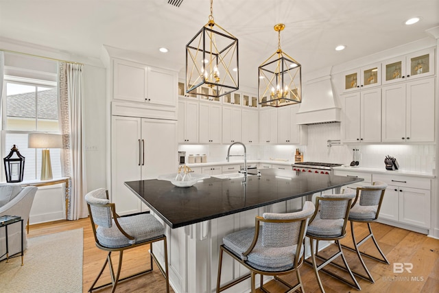 452 Colony Dr, Fairhope, AL 36532 - kitchen with white cabinets, a sink, paneled built in refrigerator, custom range hood, and range